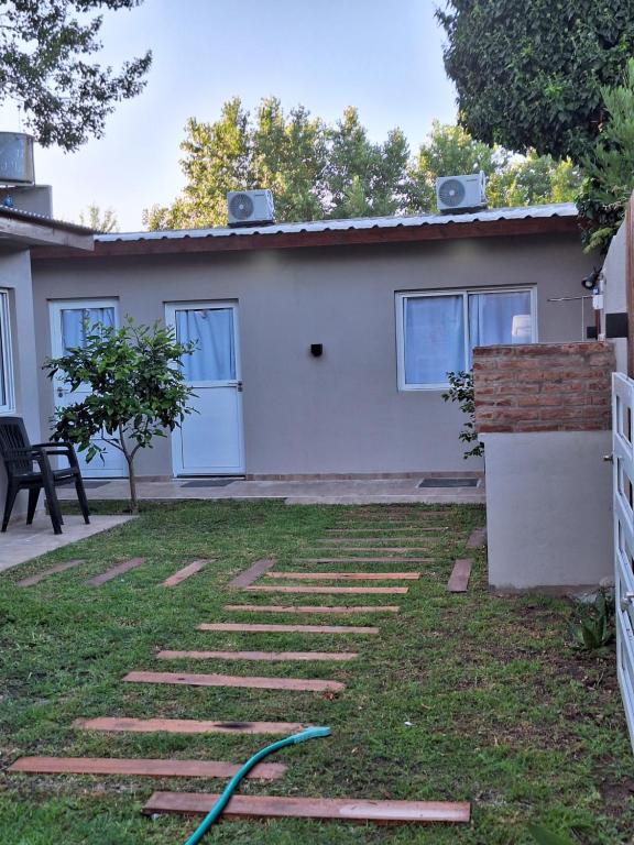 a house with a green hose in the yard at departamentos 4 personas,N3 Aire acondicionado Wifi TvCable Parrilla in Santa Teresita