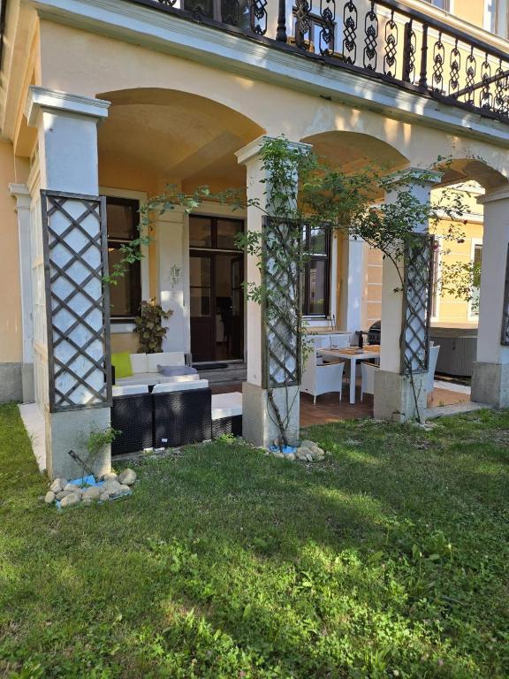 a house with an arbor and a patio at Apartment Geidorf in Graz