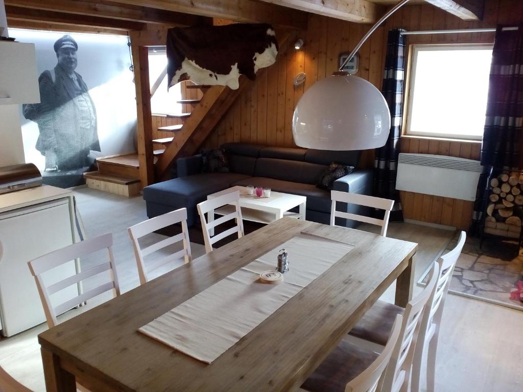 a dining room with a wooden table and chairs at Chata Eskymo in Staré Město