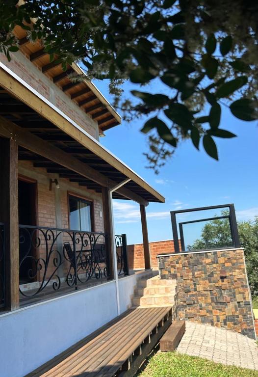a porch with a bench on a house at Chalé Alto da Copaiba in Cunha