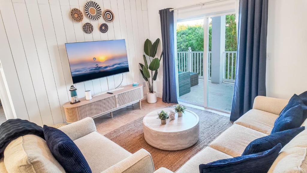 a living room with a couch and a flat screen tv at 2 BDM, 2 Bath - Bimini Bay Resort in Bailey Town