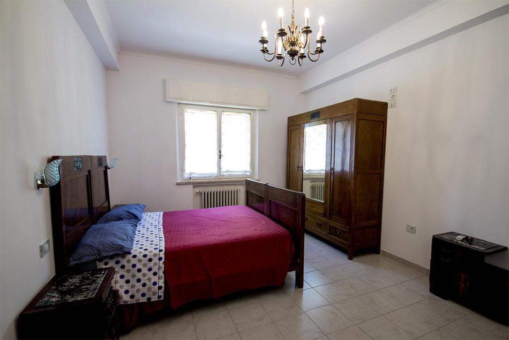 um quarto com uma cama e um lustre em Il Tiglio em Fano