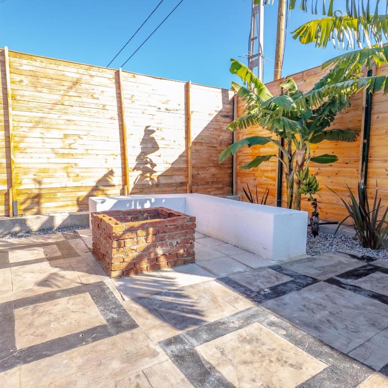 a bench in front of a wooden fence at Bugi Suit Bungalov in Erenköy