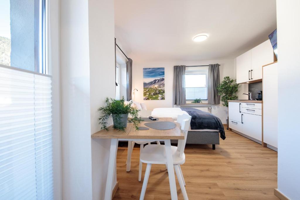 a small room with a table and a bedroom at Heu22 Herbstgold in Farchant