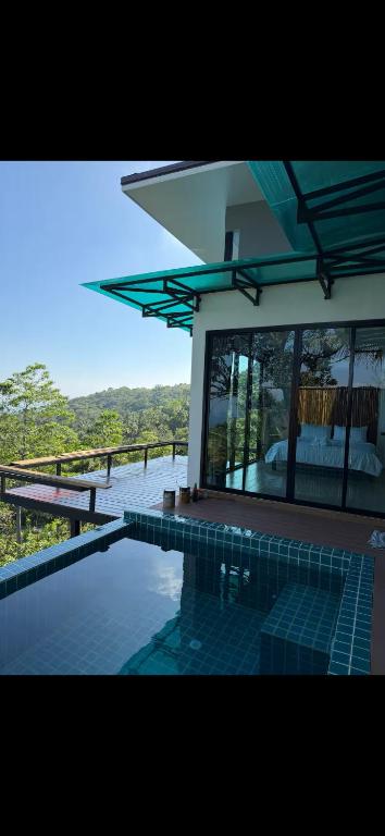 a swimming pool in front of a house at Love koh tao villa 2 in Ko Tao