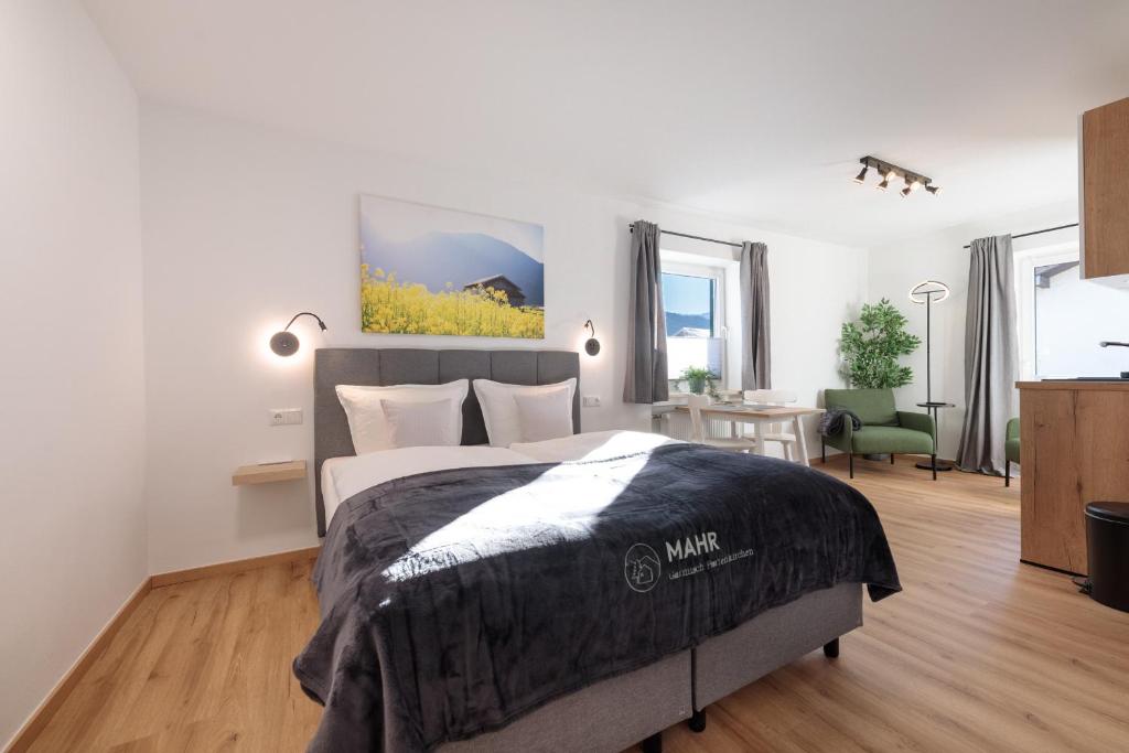 a bedroom with a bed and a desk in it at Heu22 Frühlingserwachen in Farchant