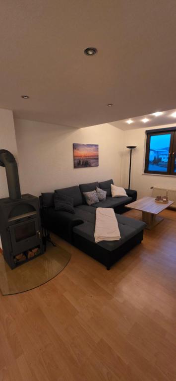 a living room with a couch and a stove at Ferienwohnung Chandony in Konz