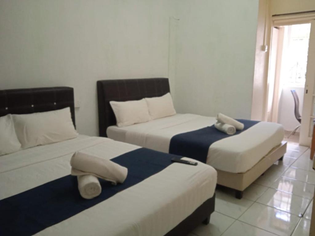 En eller flere senge i et værelse på Netasha Holiday INN