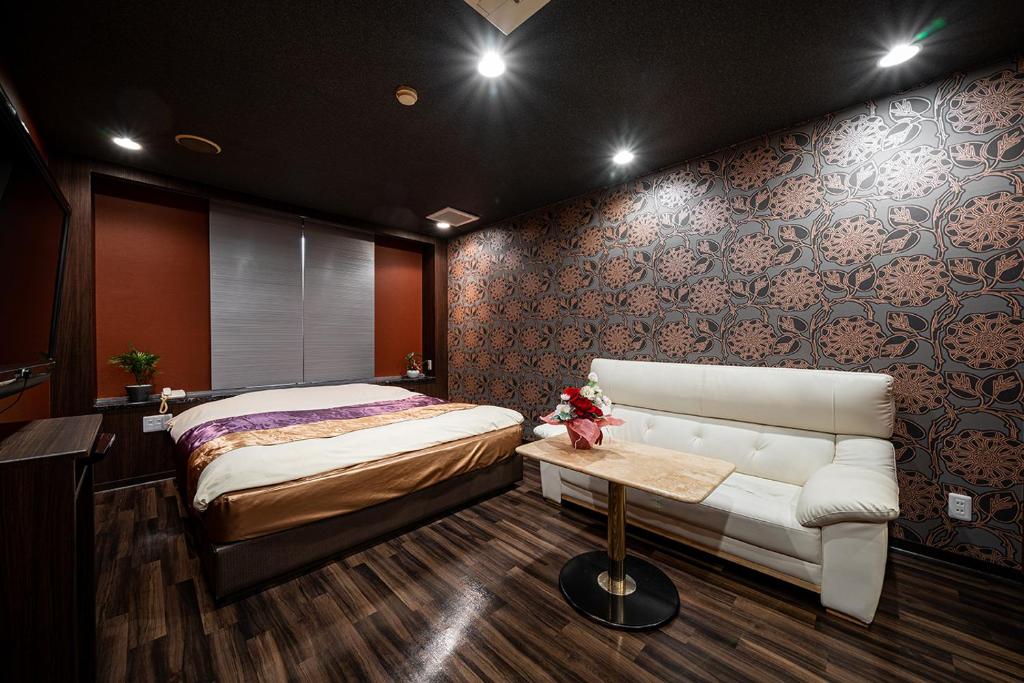 En eller flere senge i et værelse på ホテルリンクス柏市豊四季店