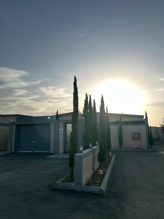 a group of trees in front of a building at شاليه ريفالا الفاخر in Abha