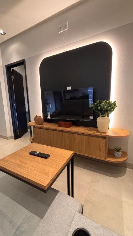 a living room with a large flat screen tv at Smart Residence Moderno in Santarém
