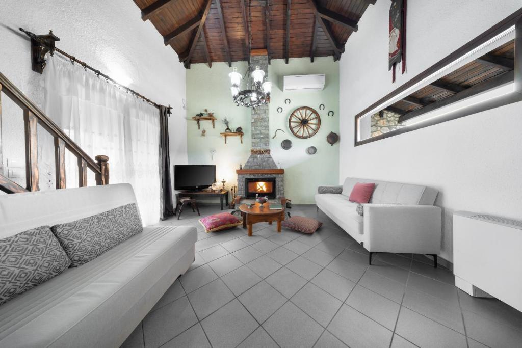 a living room with a couch and a fireplace at Chalet Renata 1 Livadi Arachovas in Kalívia