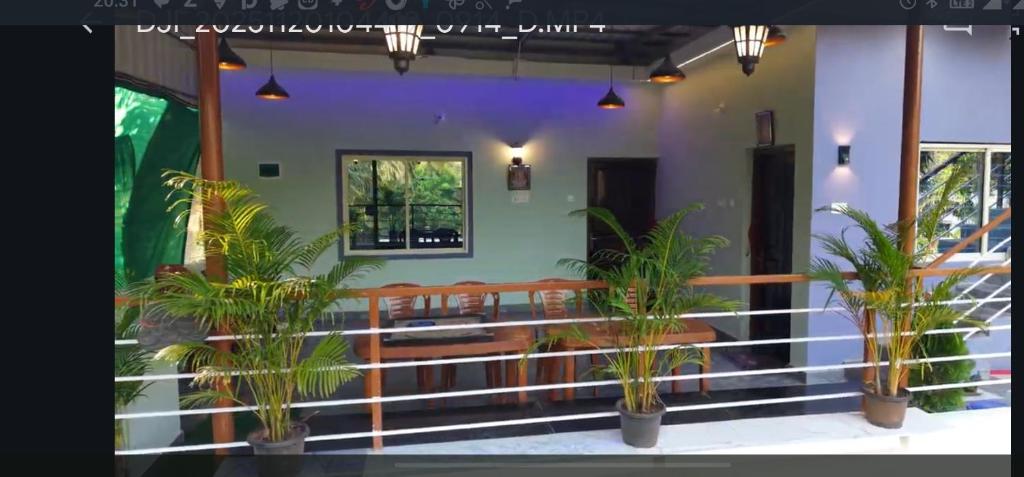 a balcony with potted plants in a building at VAISHVI Homestay in Kāsarkod