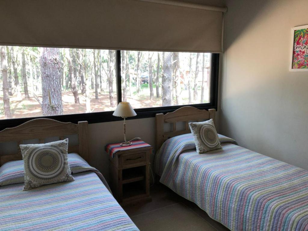 a bedroom with two beds and a window at Jardines del Bosque in Costa del Este