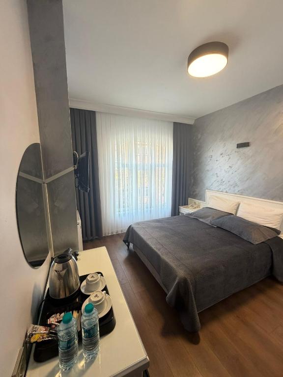 a bedroom with a bed and a table with water bottles at Fatih Resadiye Hotel in Istanbul