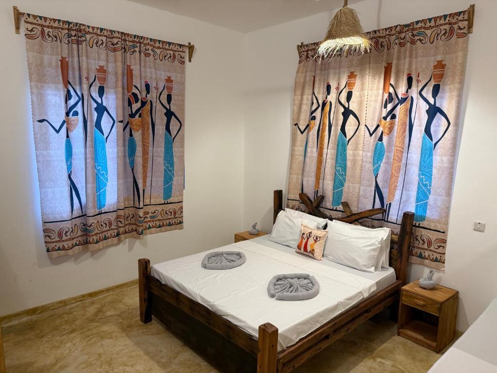 En eller flere senge i et værelse på Carpe Diem Nungwi