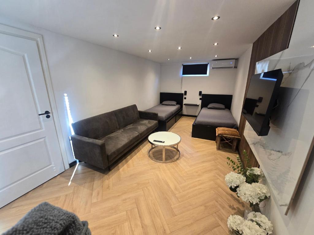 a living room with a couch and a tv at ZM Tilburg in Tilburg