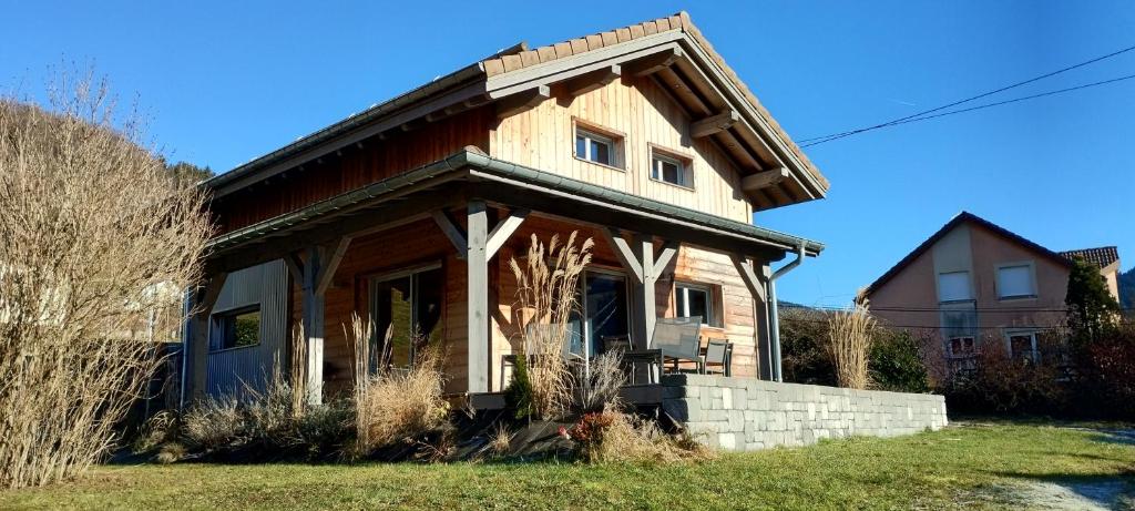 une maison en bois avec un toit à la mansarde dans l'établissement Superbe Chalet Neuf, à Cornimont