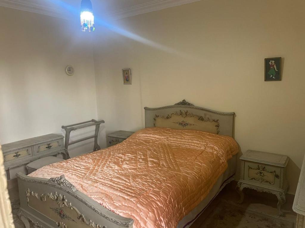a bedroom with a bed and two night stands at Ramo Square hostel in 6th Of October
