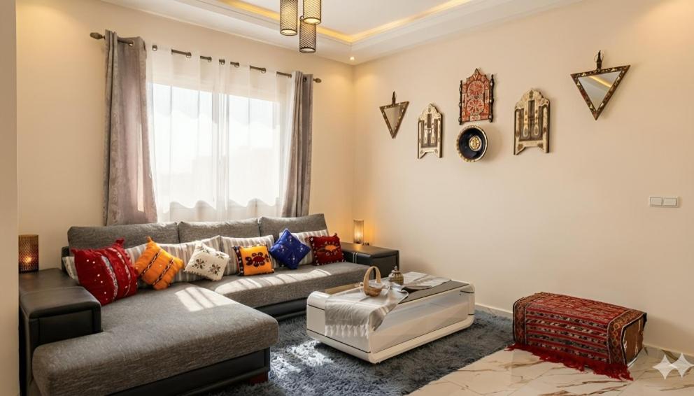 a living room with a couch and a table at Azra Homes Famille uniquement in Saidia 
