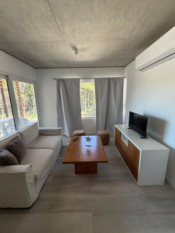 a living room with a couch and a coffee table at Departamento BOSQUE - Unidad 218 in Costa del Este
