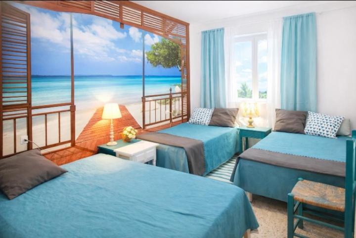 a bedroom with two beds and a view of the ocean at Can Pau Llanca Sf Parascheva in Llança