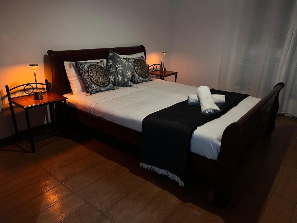 a bedroom with a large bed with pillows on it at ARTEMIS HOUSe in Kakopetria