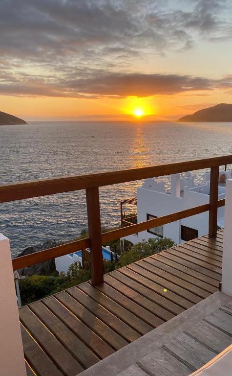 a view of the sunset from the deck of a cruise ship at Casa Santorini RJ in Arraial do Cabo