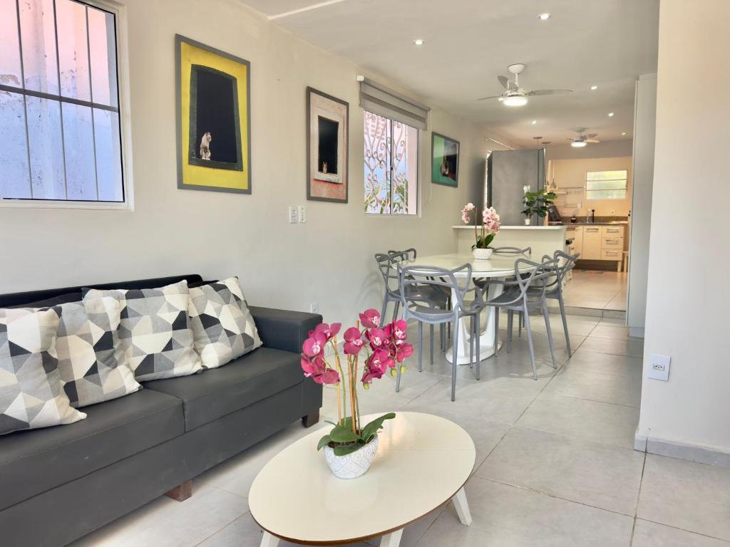 a living room with a couch and a table at Cozy House in Pipa