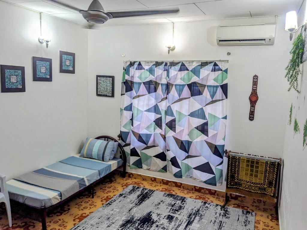 a living room with a couch and a curtain at Djalai Roomstay in Kepala Batas