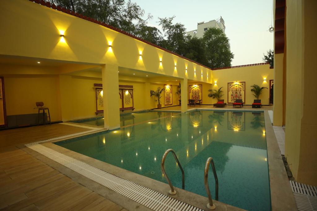 a swimming pool in the middle of a building at Hotel Ranavilas Palace in Jaipur