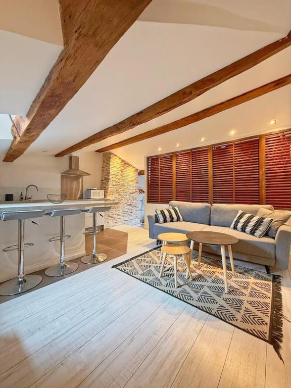 a living room with a couch and a table at Coeur Rochelais, Atypique, centre, 5 min du port in La Rochelle