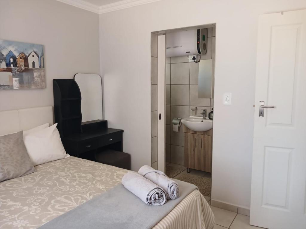 En eller flere senge i et værelse på Karoo-Hart