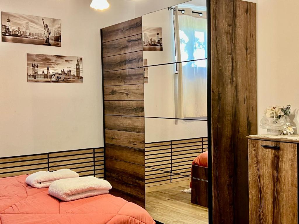 a bedroom with a shower and a bed with red sheets at Relax Home Holiday in Panicale