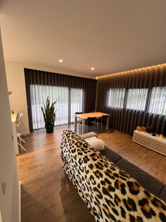 a living room with a leopard blanket on a bed at Apartamento T2 - Leiria in Leiria