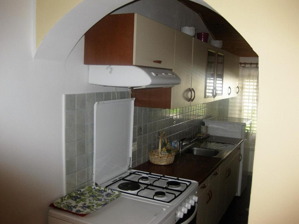 a small kitchen with a stove and a sink at Apartment Svobode Izola in Izola
