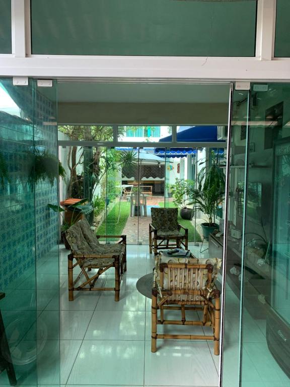 a room with two chairs and a table in a building at Mar & Mar Suites in Arraial do Cabo