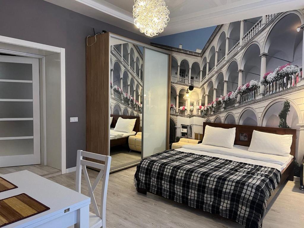 a bedroom with a bed and a living room at Апартаменти Площа Ринок in Lviv