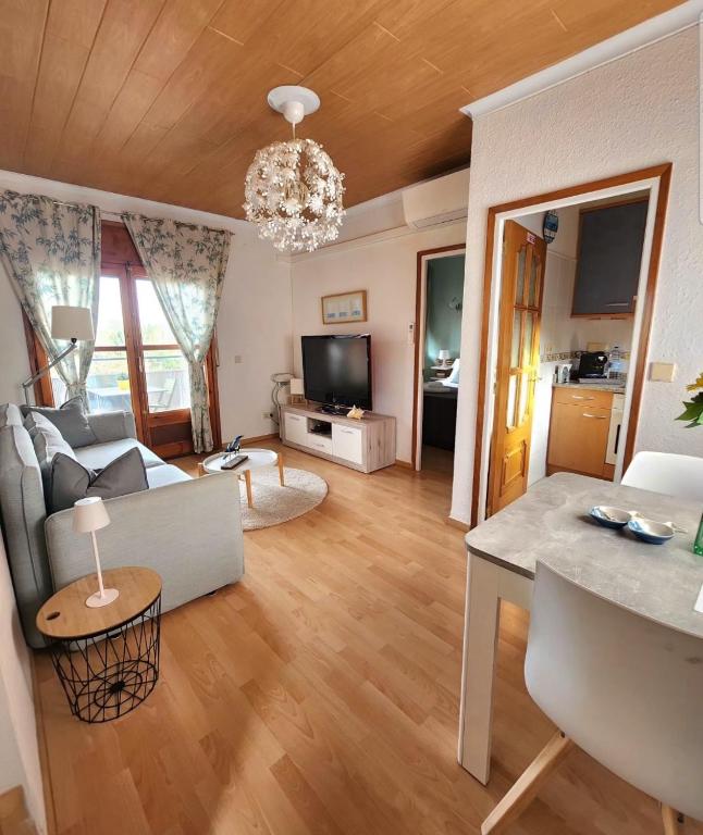 a living room with a couch and a table at Anchoveta in Calonge