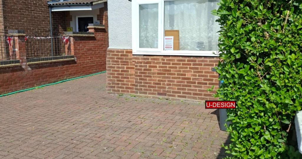 a red sign in front of a brick building at Parkside Studio in Luton