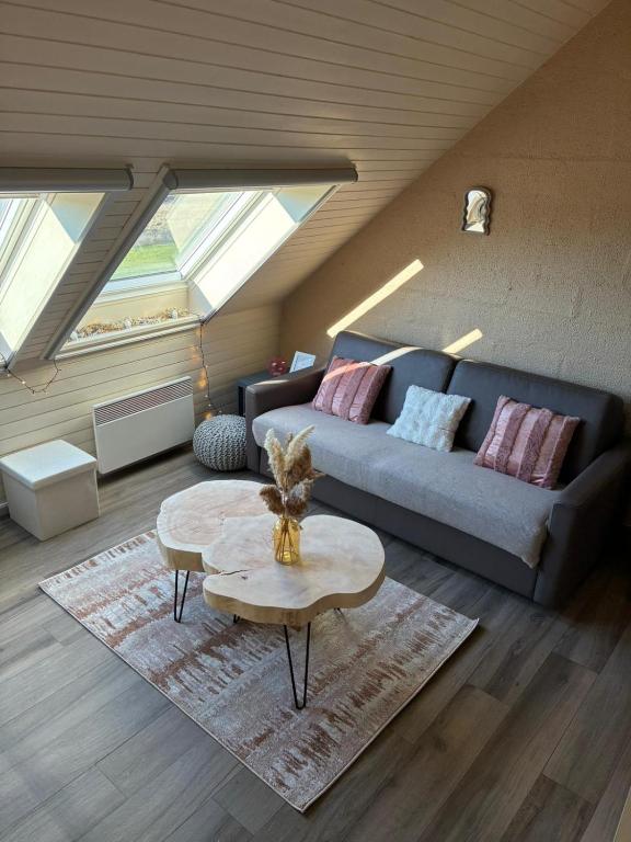 a living room with a couch and a table at Cocoon Ny II - DURBUY in Hotton