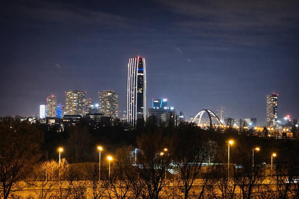 a city skyline at night with lit up buildings at 3BR - City Views - Free Parking - Near Eurovea and Aupark in Petržalka