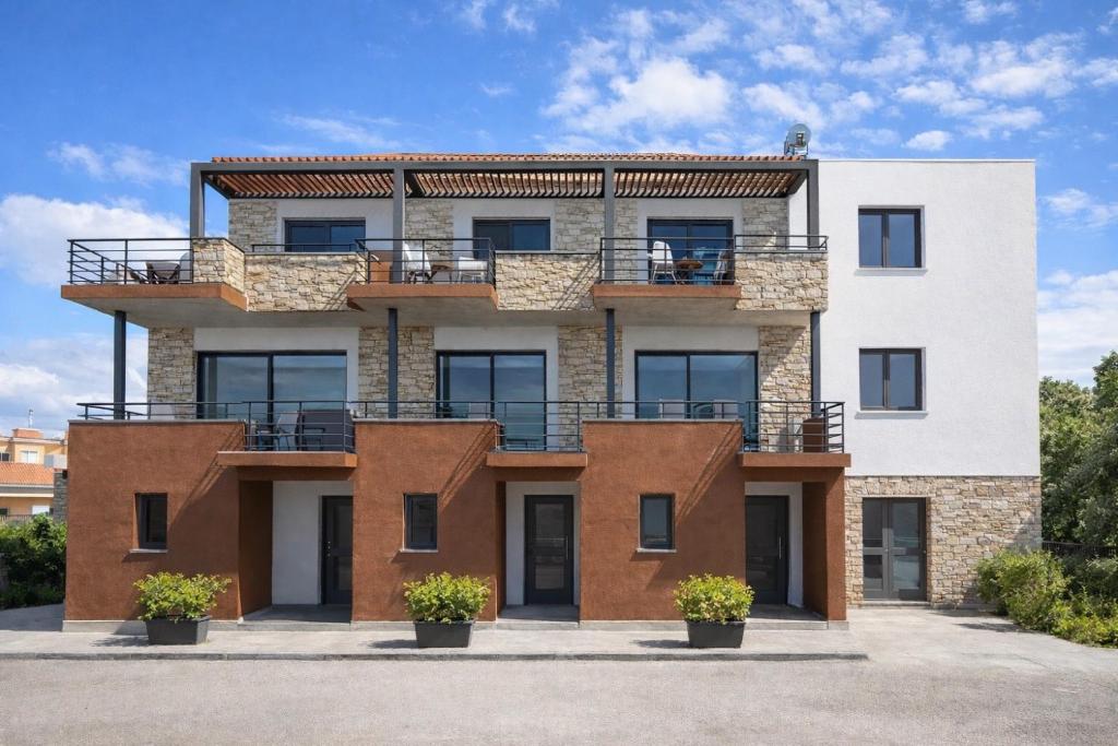 een appartementengebouw met balkons aan de zijkant bij Skiathos Bliss Villa in Skiathos-stad