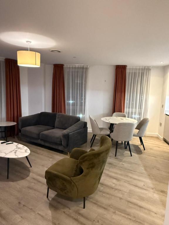 een woonkamer met een bank, stoelen en tafels bij Chalk in Moffat