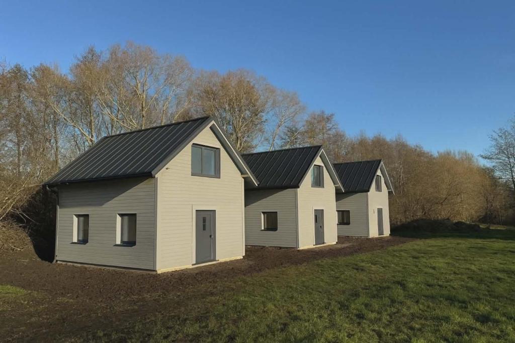 two houses on a hill in a field at Luke & House in Śliwin