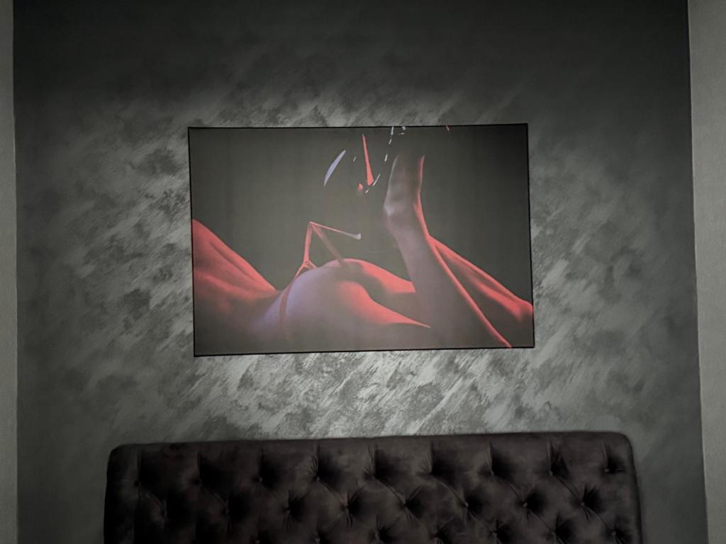 a tv hanging on a wall in a room at Turgaus 10 in Klaipėda