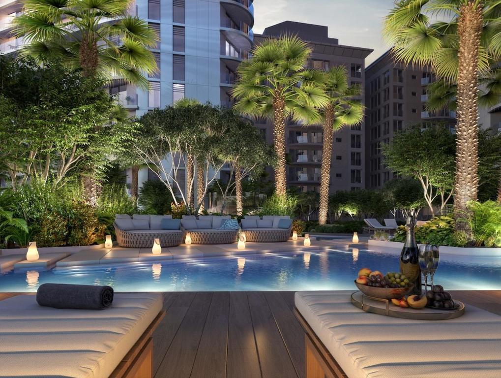 a large swimming pool with palm trees in a city at VV - Skyline Studio Pool & Gym in City Centre in Gibraltar