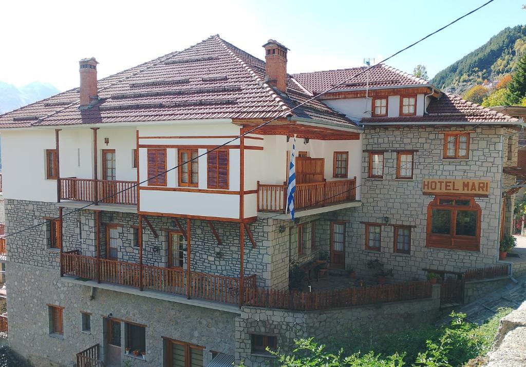 a large brick house with a porch and a balcony at HOTEL MARI Metsovo in Metsovo