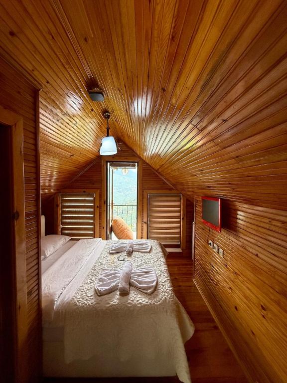 a bedroom with a large bed with towels on it at Isgobya Sumela Monastery 106 in Macka