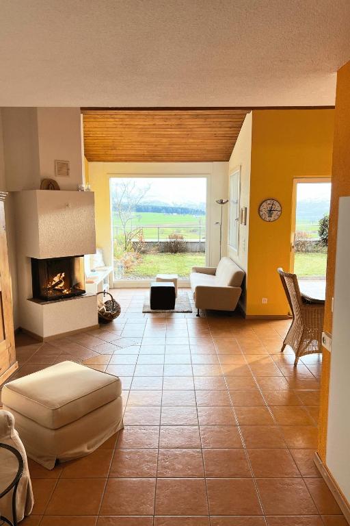 a living room with a couch and a fireplace at Charming house with mountain view in Hämikon